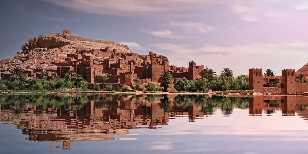 Ancient desert fortress reflected in a calm river